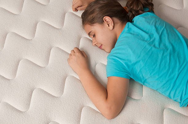 Little girl lying down on her new comfortable mattress.Click for some HOT stuff (100 or more downloads).